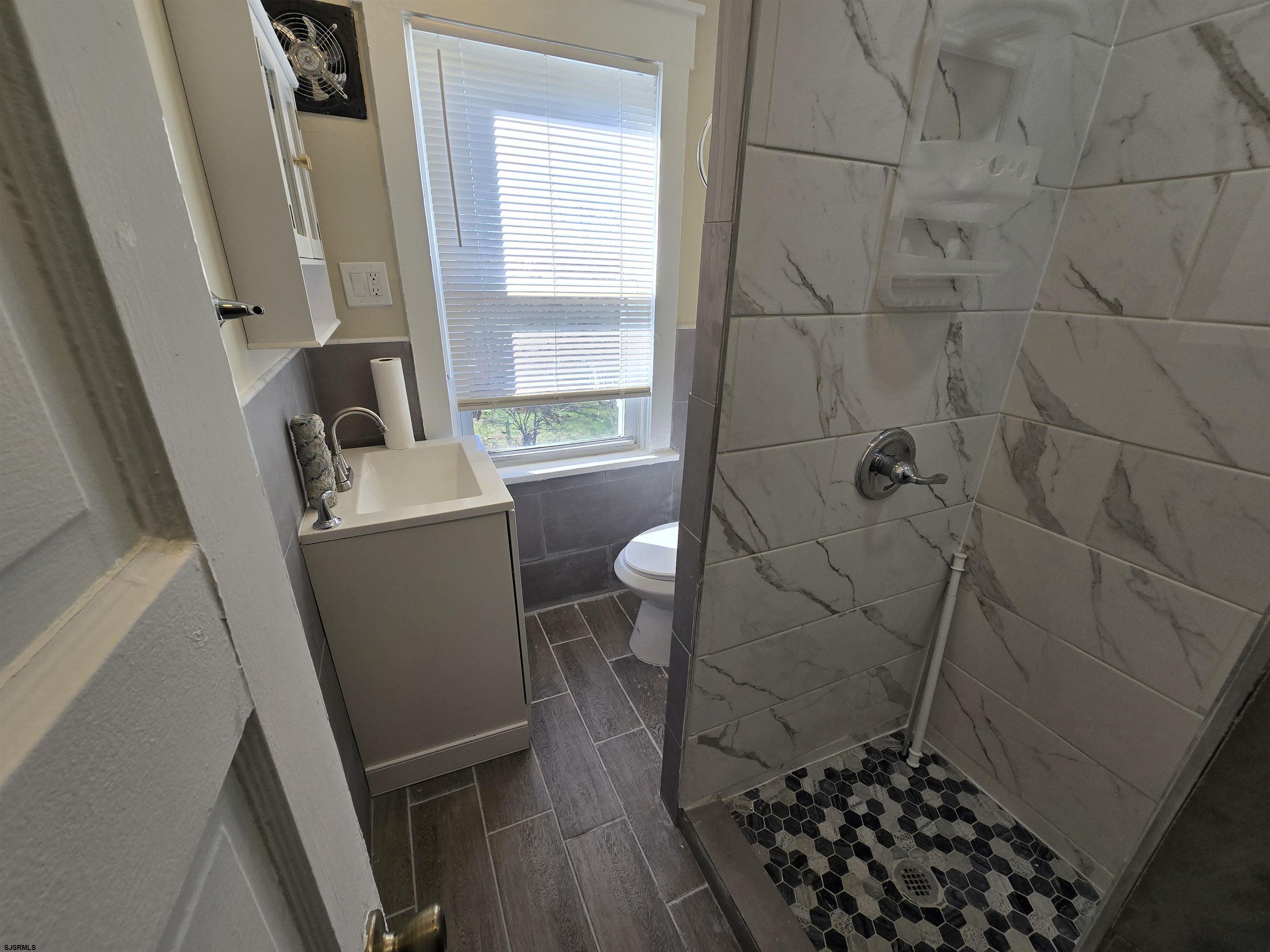 1528 Madison Avenue, Unit B Atlantic City, NJ 08401 - Photo 10 of 12 a bathroom with a sink toilet and shower