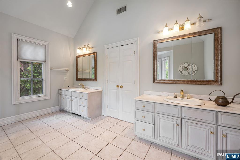 4 Hetzel Drive Mahwah, NJ 07430 - Photo 18 of 29 a bathroom with a double vanity sink mirror and bathtub