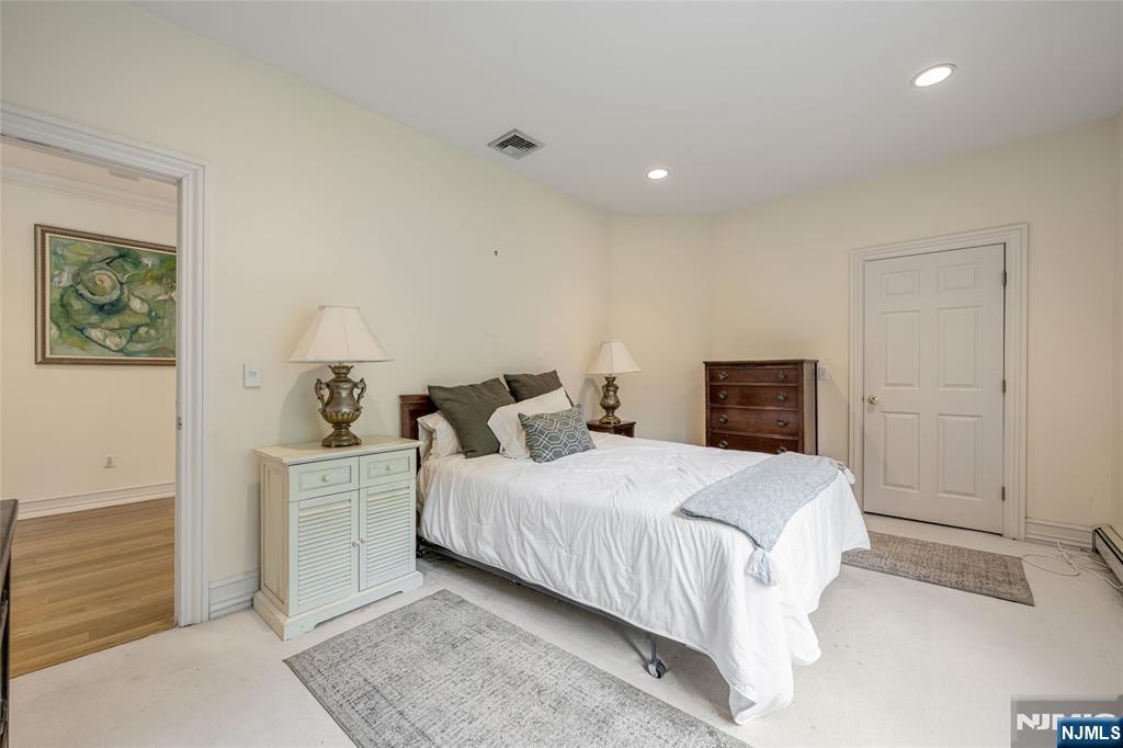 4 Hetzel Drive Mahwah, NJ 07430 - Photo 20 of 29 a bedroom with a bed and a table