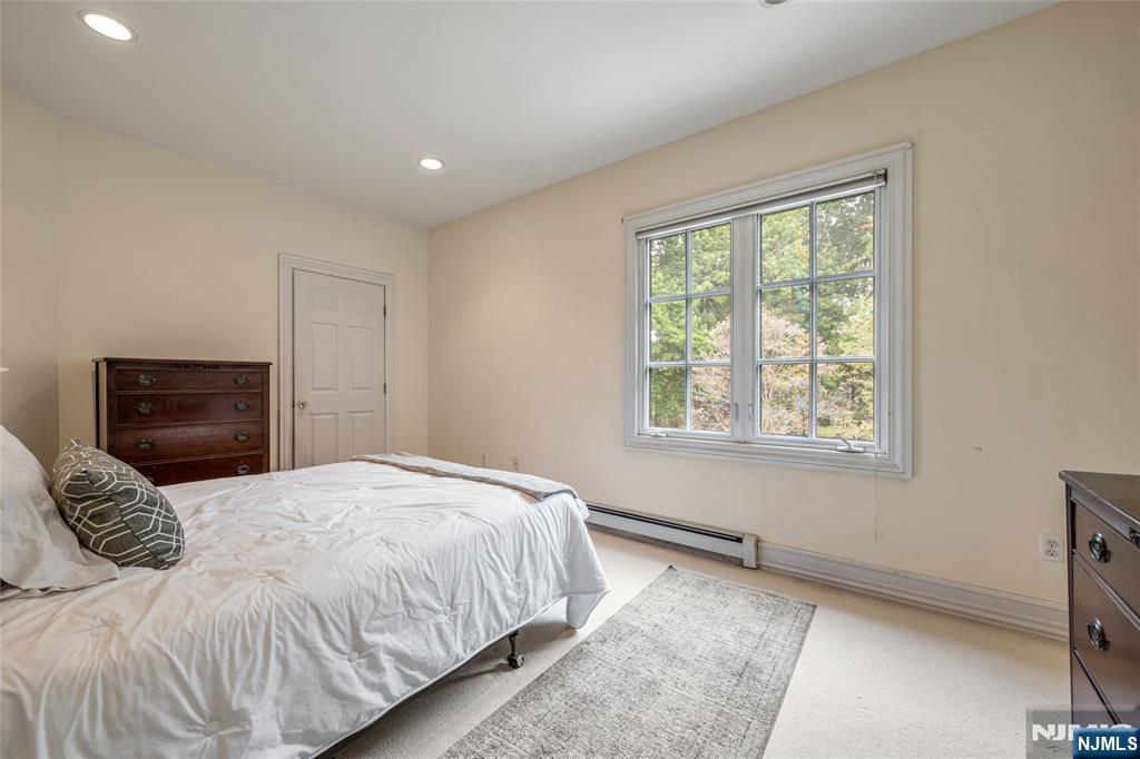 4 Hetzel Drive Mahwah, NJ 07430 - Photo 21 of 29 a bedroom with a large bed and a tv