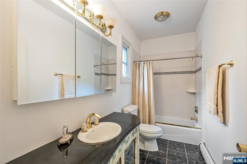 4 Hetzel Drive Mahwah, NJ 07430 - Photo 22 of 29 a bathroom with a sink toilet a mirror and shower