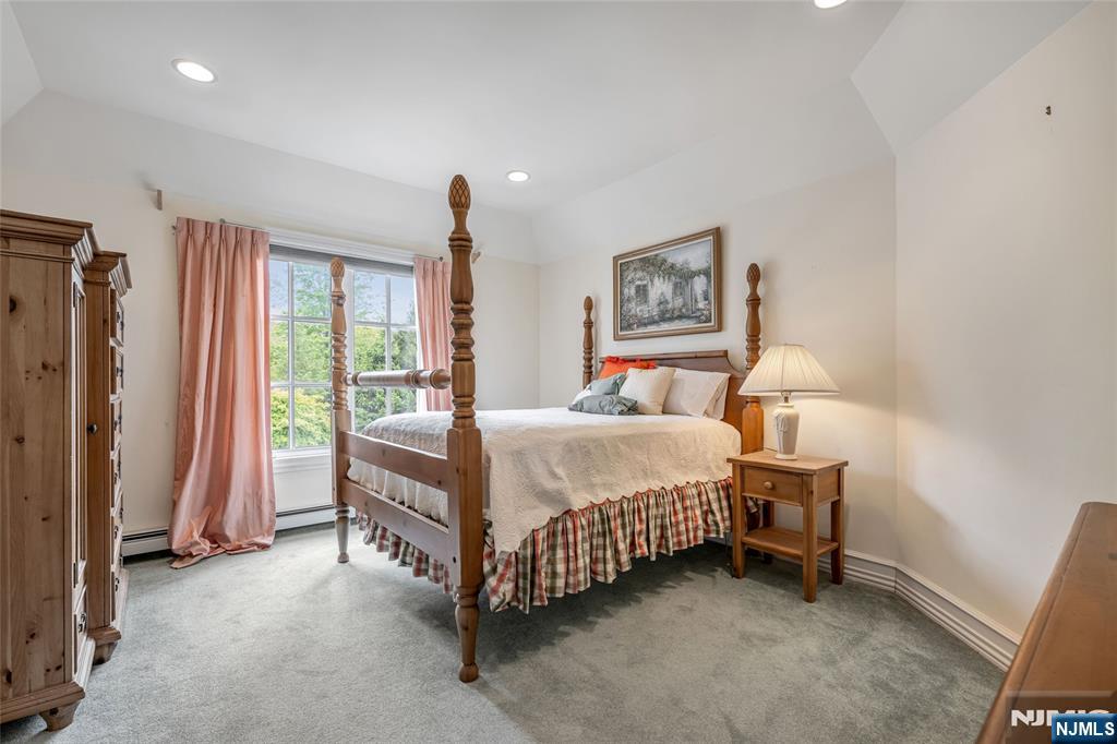 4 Hetzel Drive Mahwah, NJ 07430 - Photo 25 of 29 a bed sitting in a room next to a window