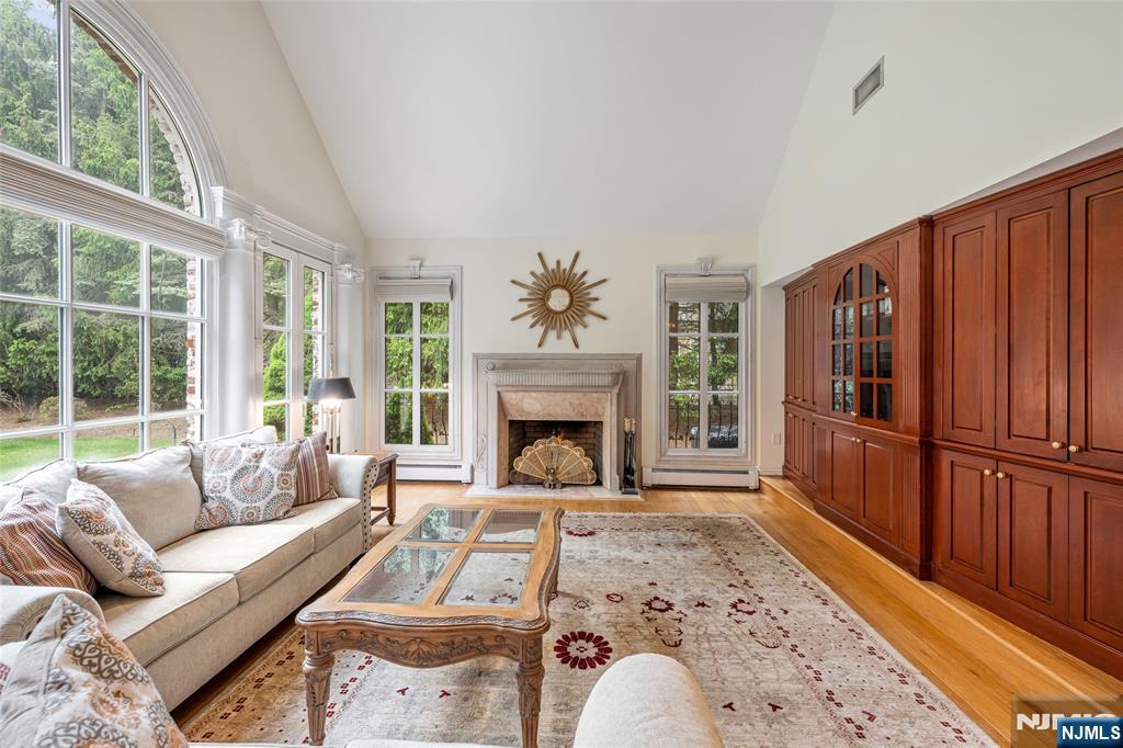 4 Hetzel Drive Mahwah, NJ 07430 - Photo 4 of 29 a living room with furniture a fireplace with wooden floor