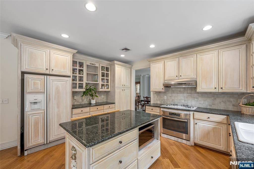 4 Hetzel Drive Mahwah, NJ 07430 - Photo 9 of 29 a kitchen with stainless steel appliances granite countertop a stove and a refrigerator