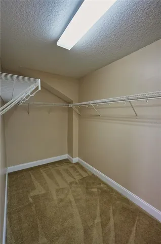 a view of a hallway with wooden shelves