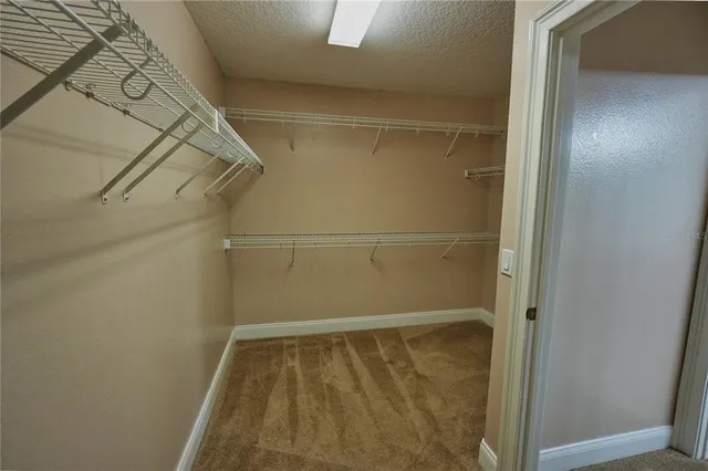 a view of staircase with railing and a chandelier