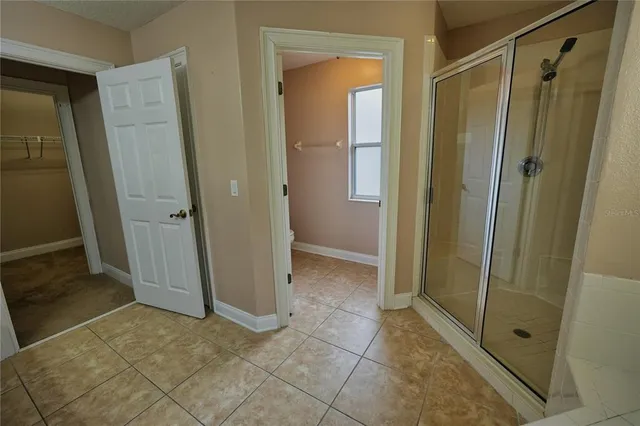 a view of a house with brick walls and a yard with plants