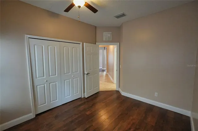 a kitchen with granite countertop a stove top oven microwave and cabinets