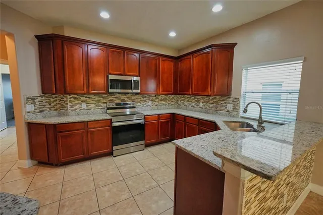 a view of a house with a door and a yard