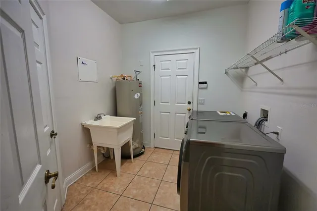 a front view of a house with a garden and trees