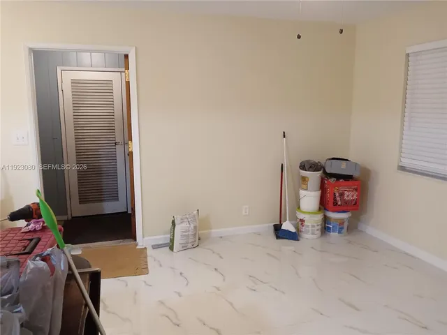 a view of backyard of house with wooden fence