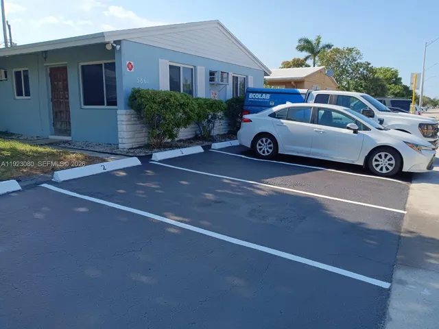 a front view of a house with parking space