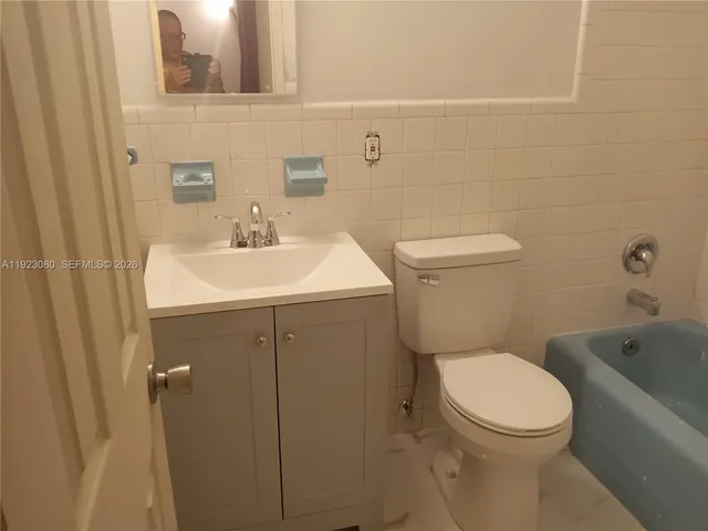 a white toilet sitting next to a bathroom sink