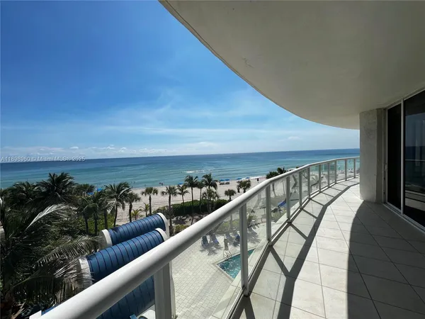 a view of swimming pool with seating area and furniture