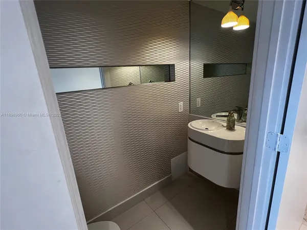 a bathroom with a sink and mirror