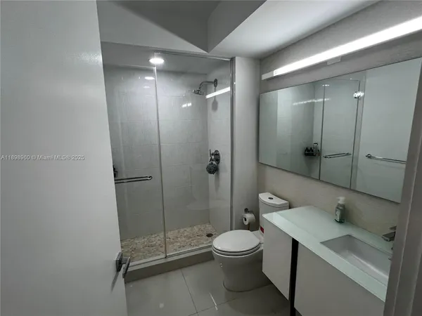 a bathroom with a toilet a sink and shower