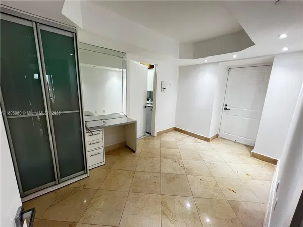 a view of a kitchen with refrigerator and sink
