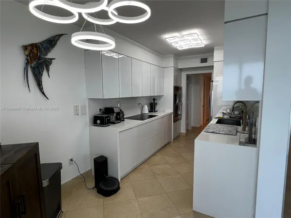 a kitchen with a sink appliances and cabinets