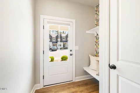 a view of an entryway with wooden floor