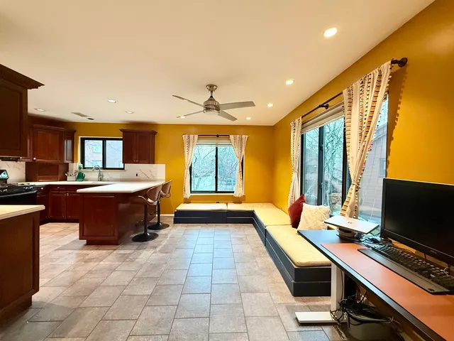 a large kitchen with a large counter top space a sink and a window