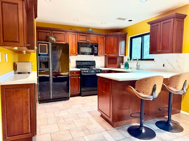 a kitchen with stainless steel appliances granite countertop a sink counter space cabinets and a appliances