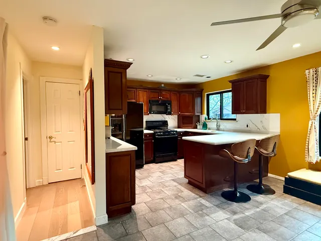 a kitchen with a sink refrigerator and cabinets
