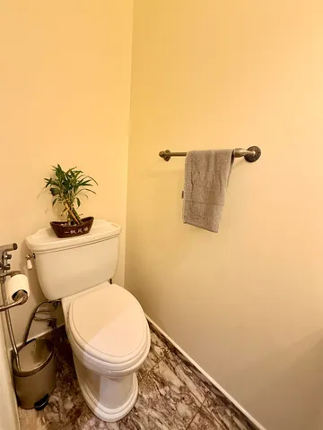 a white toilet sitting next to a bathroom sink