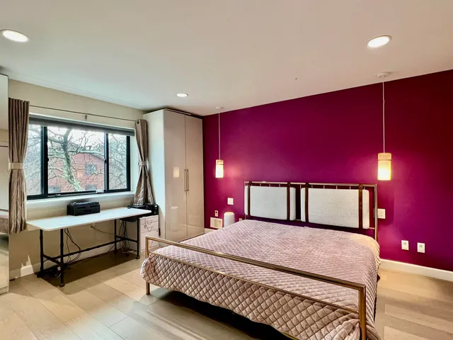 a bedroom with a large bed and a window