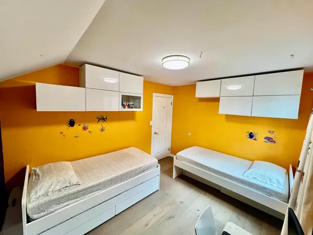 a bedroom with a bed and lamp