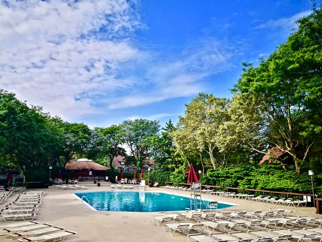 a view of a patio with a table and chairs under an umbrella