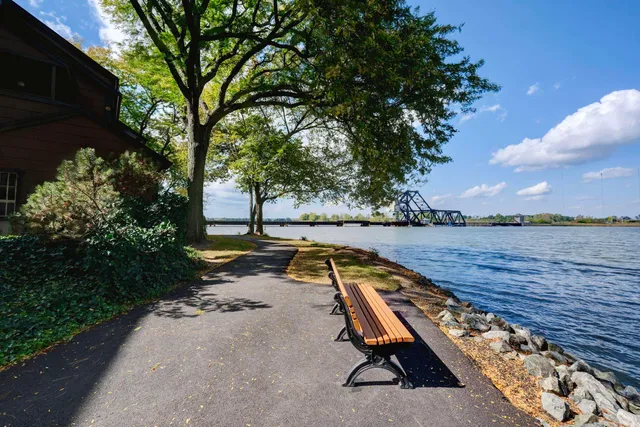 a wooden bench sitting next to a lake