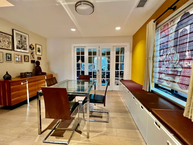 a dining room with furniture and wooden floor