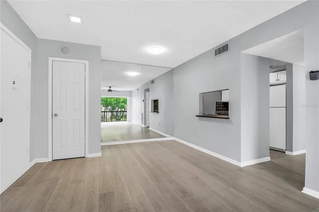 a view of a livingroom with wooden floor and a window