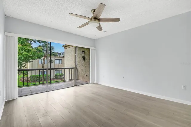 a view of a livingroom with a ceiling fan and hardwood floor