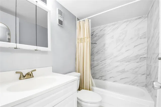 a bathroom with a sink a toilet and a bathtub