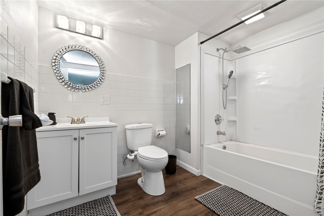 2684 Arthur Road Springfield, OH 45502 - Photo 28 of 69 This clean and functional bathroom features a shower-tub combination, wood-look flooring, and a single vanity.