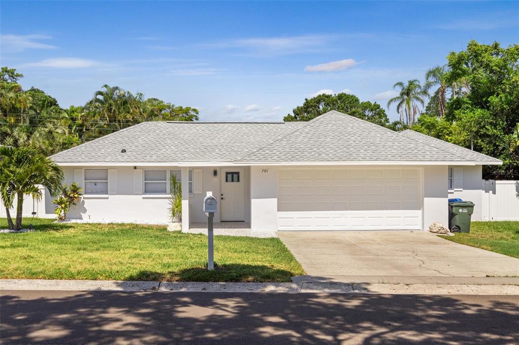 701 25th Street Southwest Largo, FL 33770 - Photo 1 of 1 a front view of a house with a yard and garage