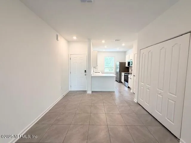 a view of a kitchen with a refrigerator and a window