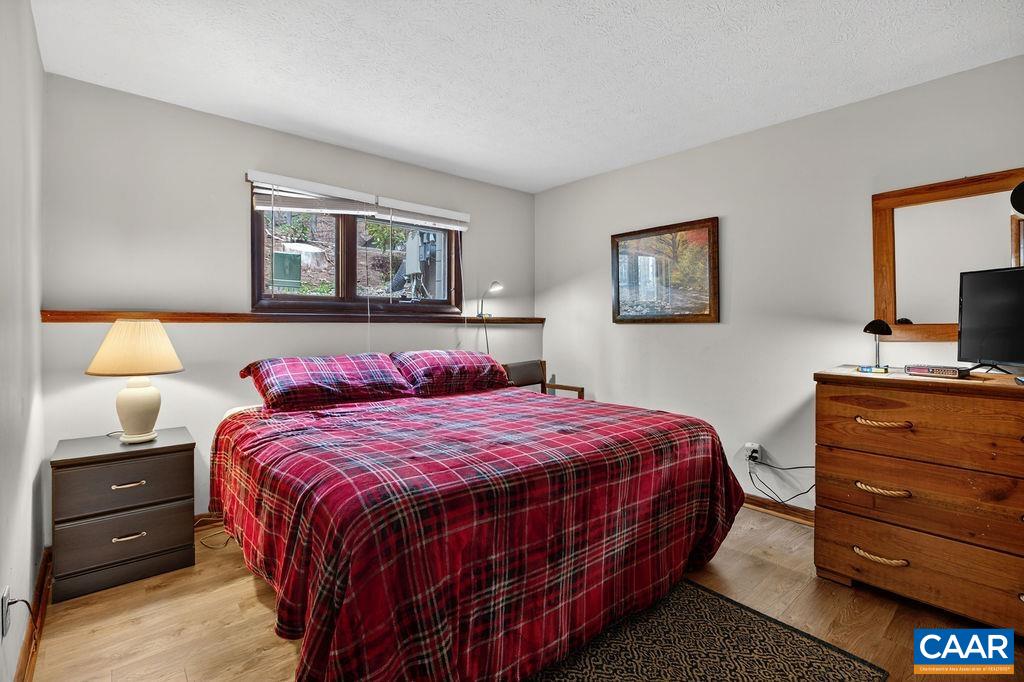 472 Three Ridges Wintergreen, VA 22967 - Photo 11 of 16 a bedroom with a bed and a tv on dresser