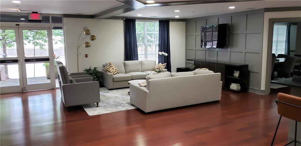 1101 Juniper Street Northeast, Unit 1416 Atlanta, GA 30309 - Photo 32 of 48 a living room with furniture and a flat screen tv
