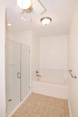 a bathroom with a granite countertop toilet sink and mirror