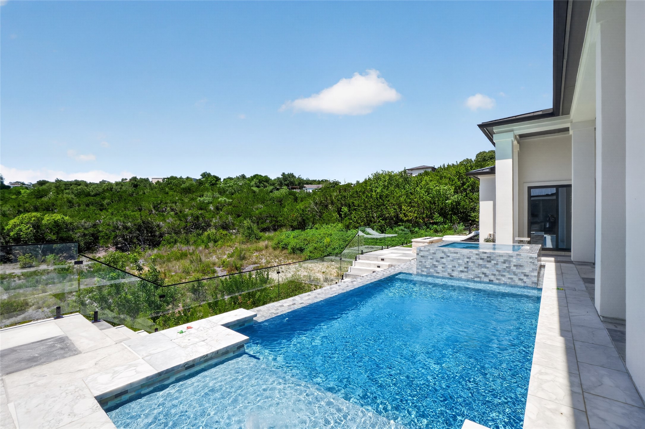 14916 Copper Ridge Lane Austin, TX 78734 - Photo 28 of 35 An inviting private pool and spa create an outdoor oasis with expansive natural views.