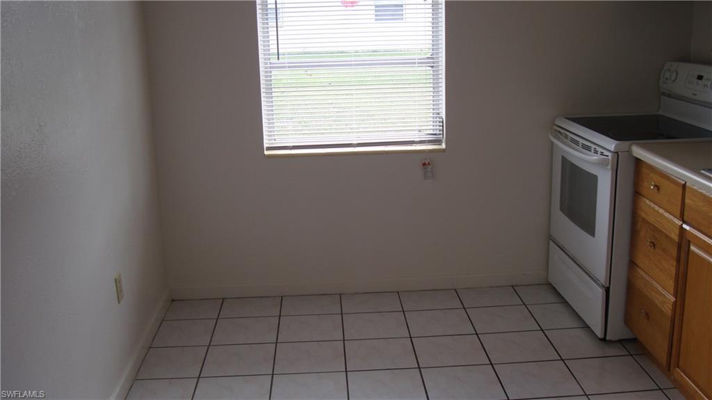 302 East Jersey Road Lehigh Acres, FL 33936 - Photo 3 of 10 a view of an empty room with a window