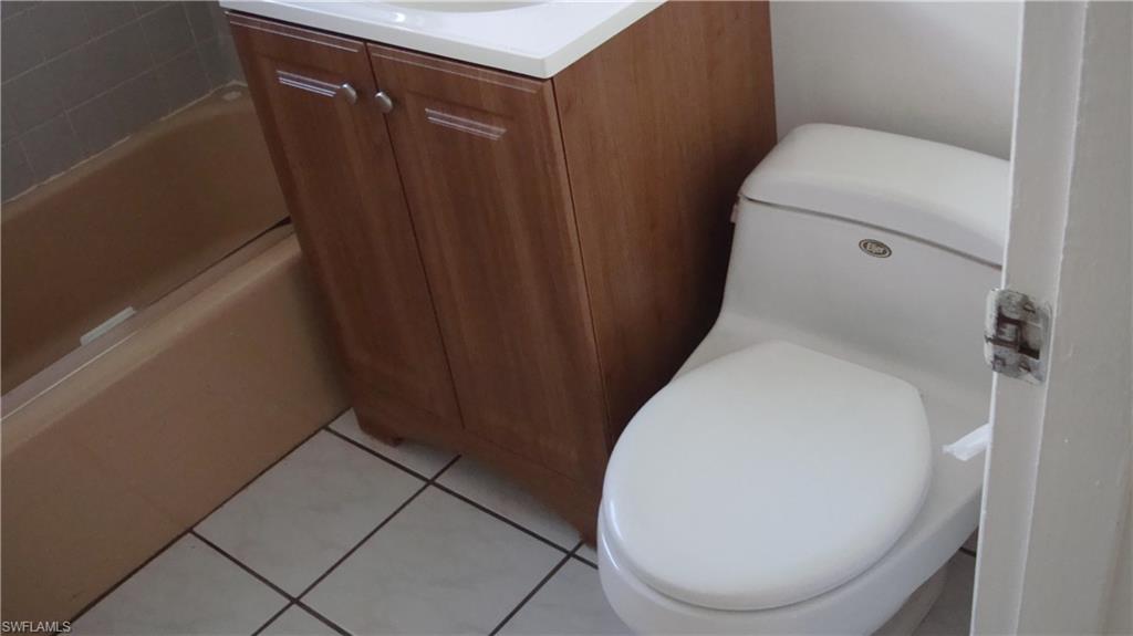 302 East Jersey Road Lehigh Acres, FL 33936 - Photo 5 of 10 a bathroom with a toilet and a sink
