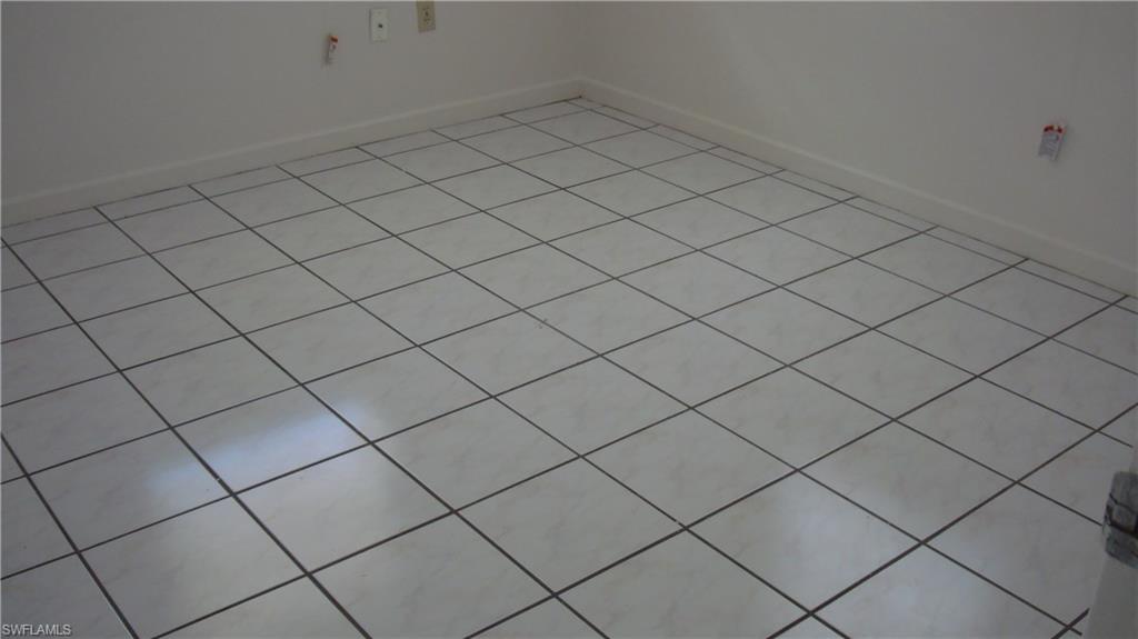 302 East Jersey Road Lehigh Acres, FL 33936 - Photo 6 of 10 a view of a garage and window