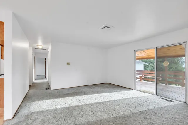 a bedroom with a large bed and windows