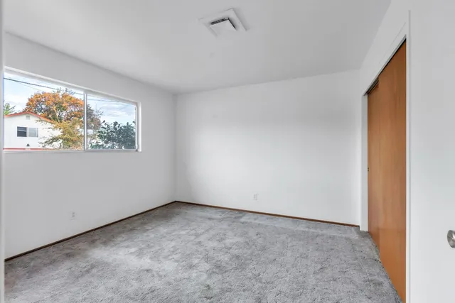 a bedroom with a bed and window