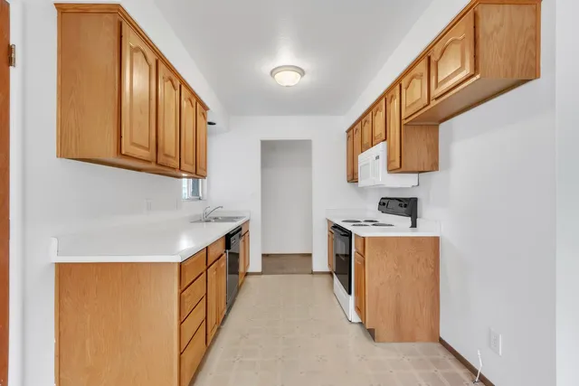 a kitchen with stainless steel appliances granite countertop a stove and a refrigerator