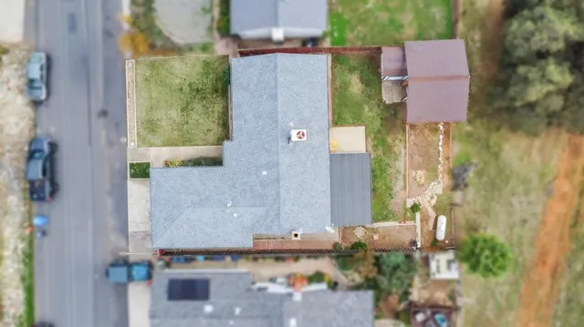 an aerial view of a house with a yard
