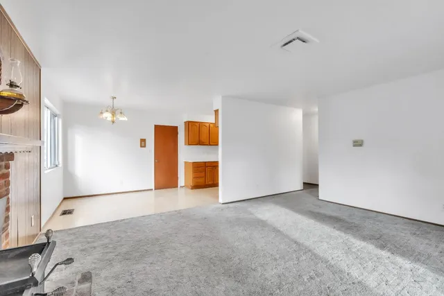 a living room with furniture a fireplace and a large window